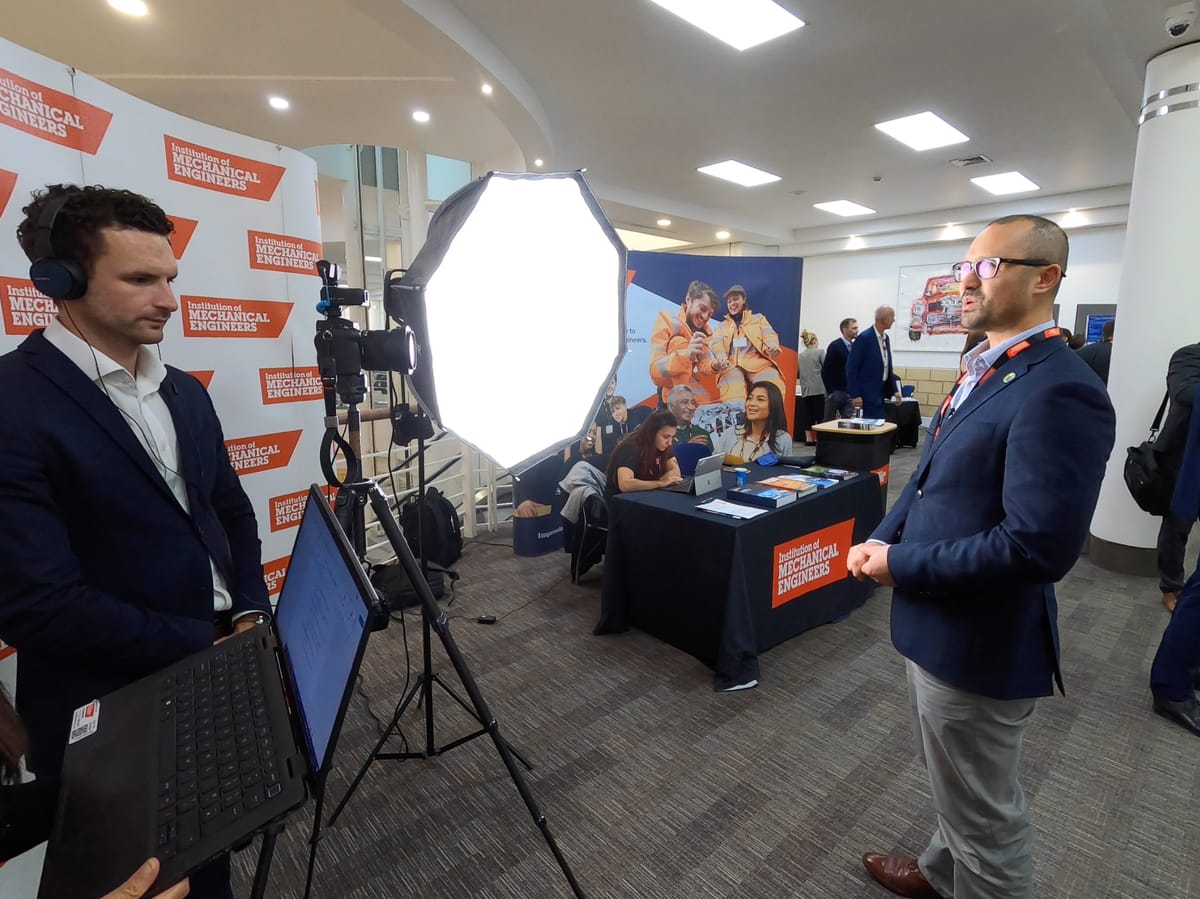 Filming interviews at an Institution of Mechanical Engineers event, monitoring the shot on a laptop.